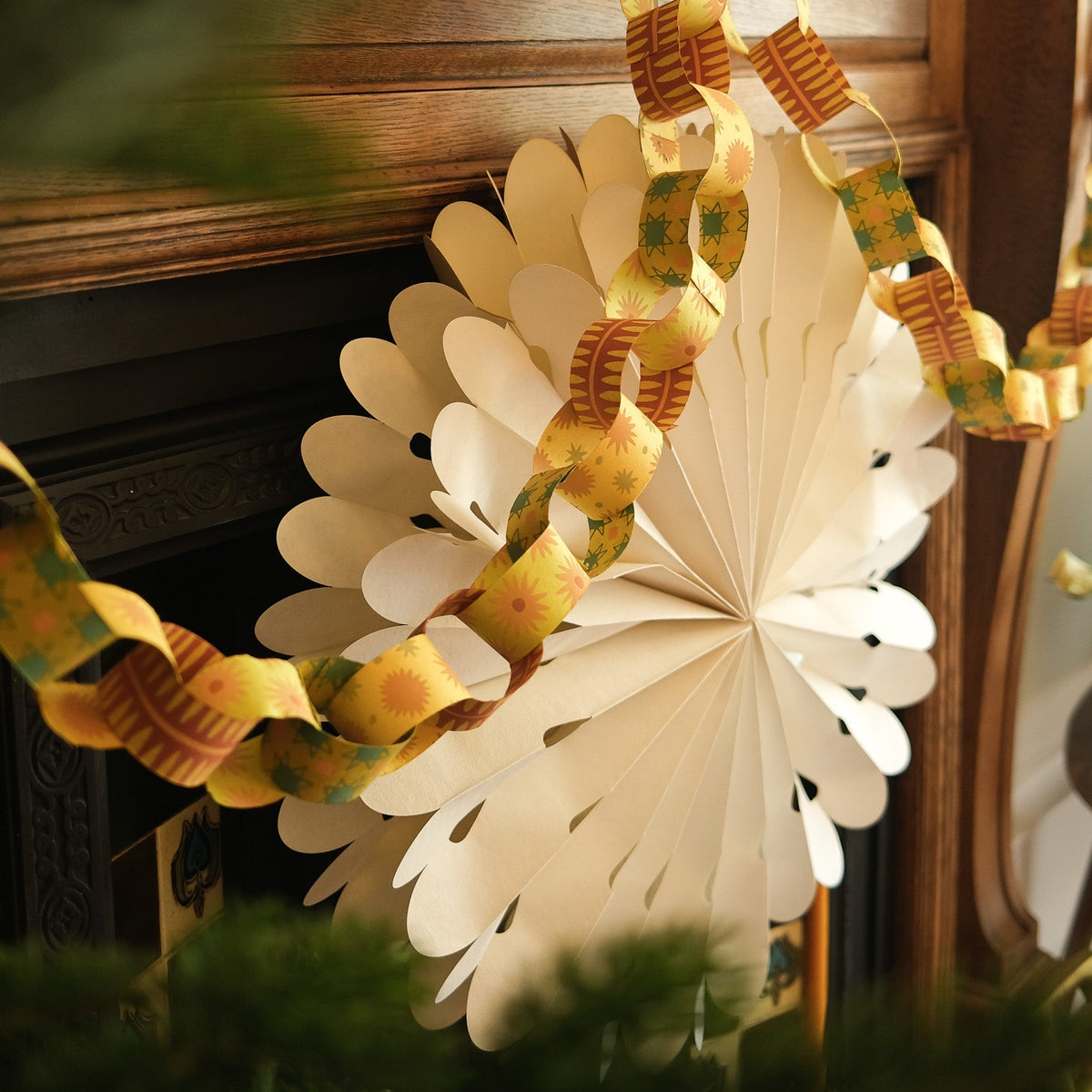 Decorative paper star with paper chains on a wooden background