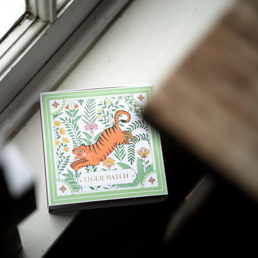 Box of matches with a tiger design on a windowsill
