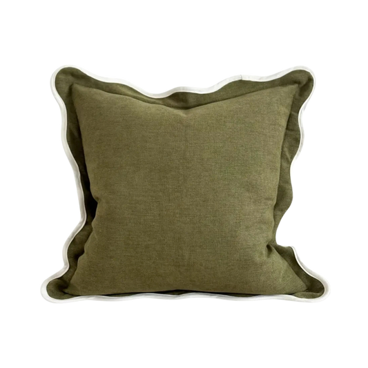 An olive green cushion with a textured linen-like fabric and a cream scalloped edge.