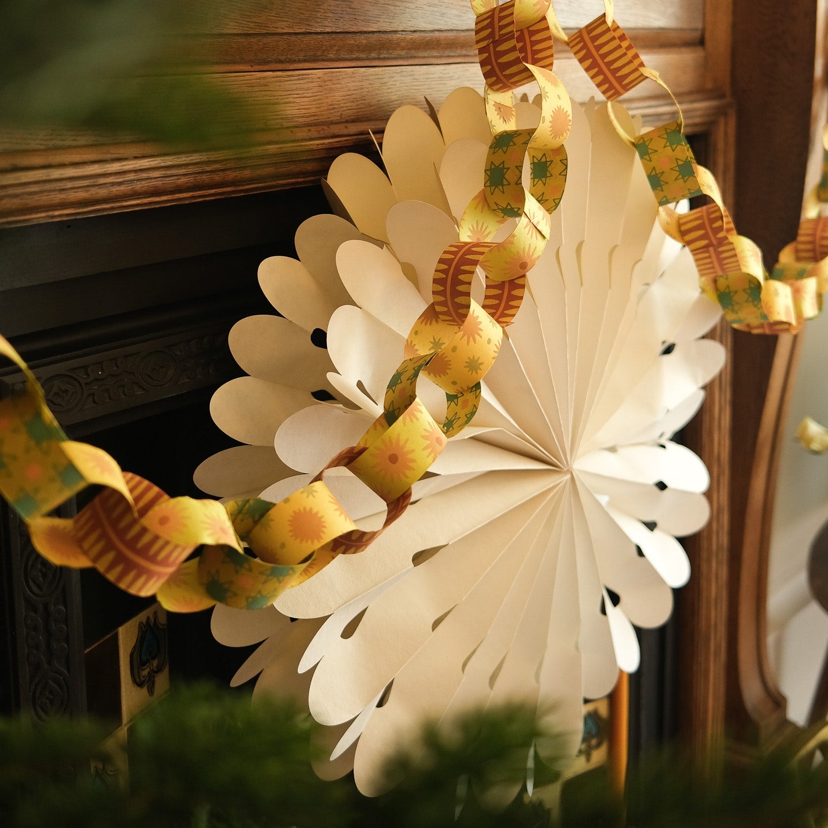 Decorative paper star with paper chains on a wooden background