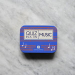 Load image into Gallery viewer, Blue tin with &#39;Quiz in a Tin Music&#39; text on a marble surface

