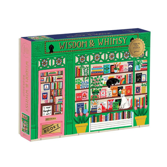A 1000-piece jigsaw puzzle box titled 'WISDOM & WHISKY' by The Letters, featuring a colorful illustration of a bookshop window with shelves, books, plants, and cats.