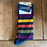 Load image into Gallery viewer, Colourful striped men&#39;s sock with a &#39;Quintessential Cambridge&#39; label on a wooden surface
