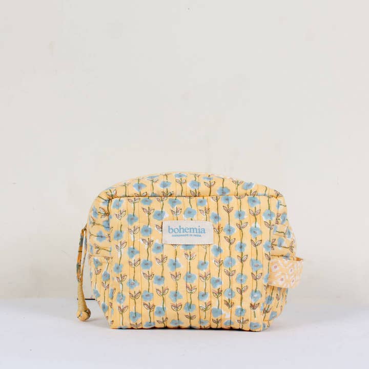 Yellow floral patterned washbag with 'bohemia' branding on a white background