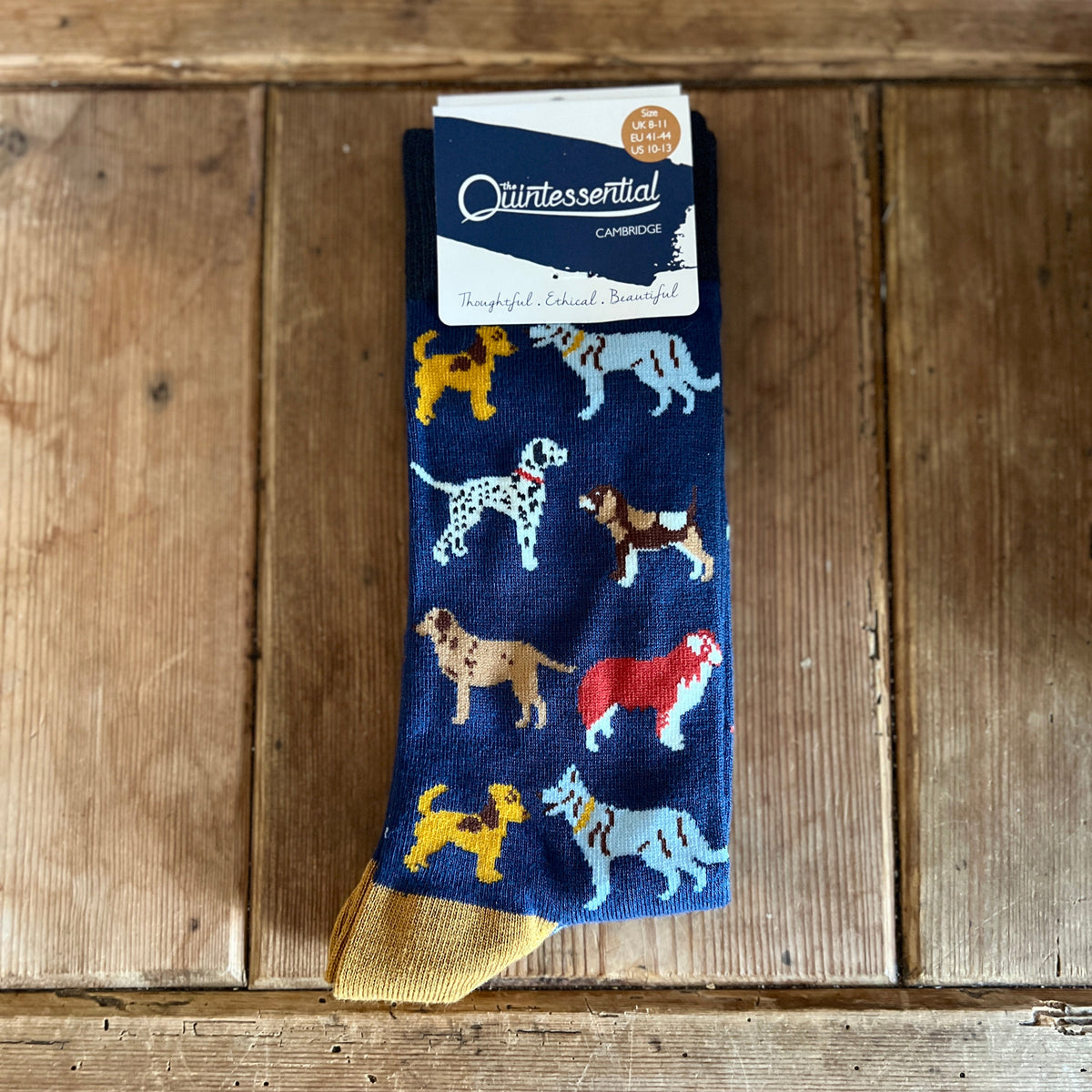 Navy sock with dog pattern on a wooden surface