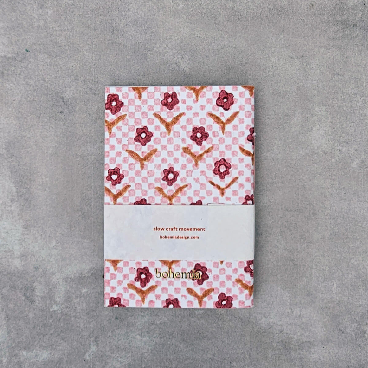 Notebook with floral pattern on a gray surface
