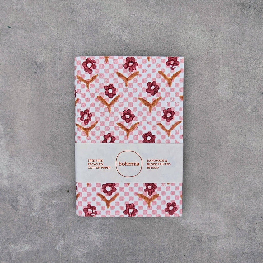 Notebook with floral pattern on a gray surface