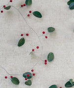 Load image into Gallery viewer, Decorative string with green leaves and red berries on a textured beige background
