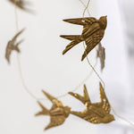 Load image into Gallery viewer, Gold bird-shaped garland on a white background
