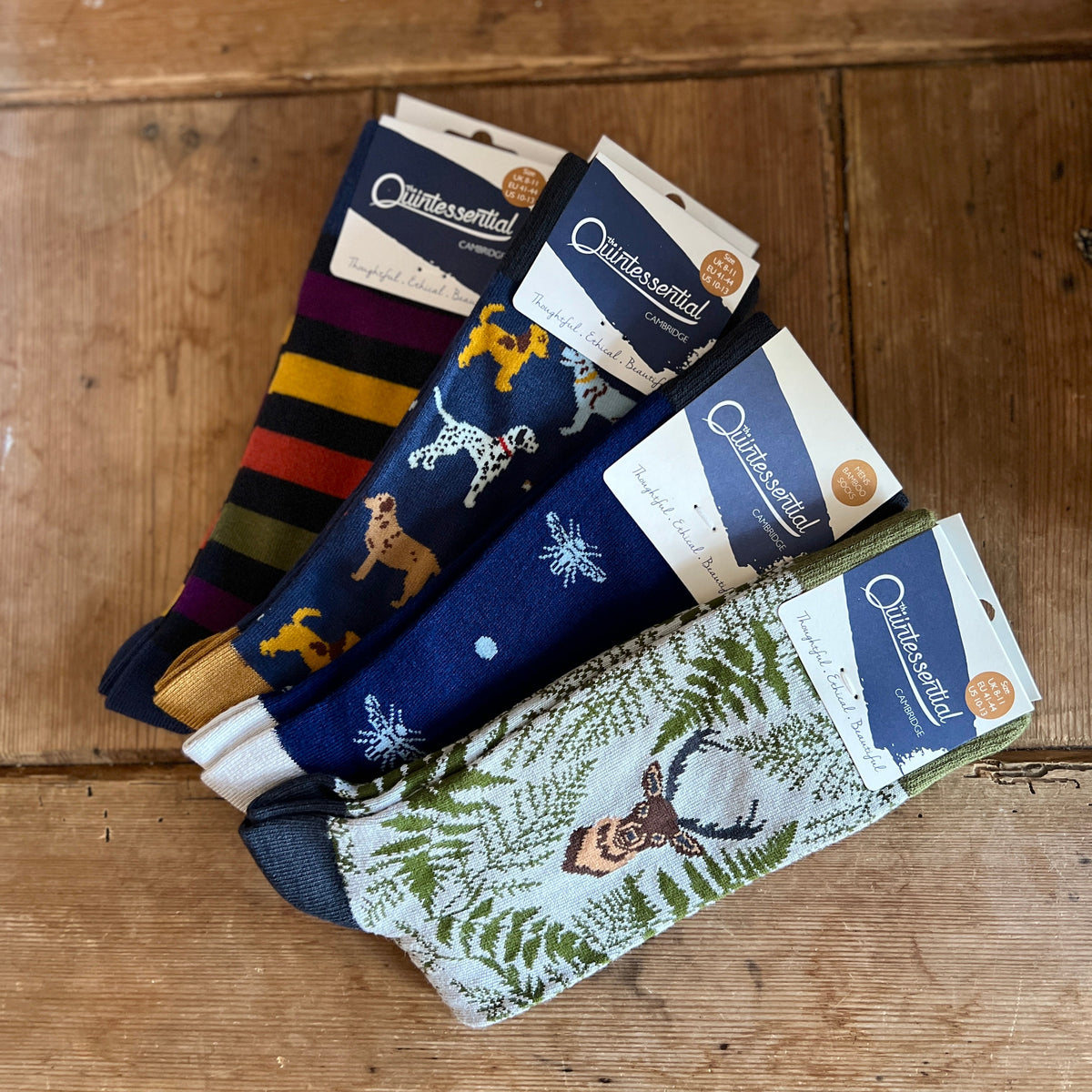 Set of men's socks with various designs on a wooden surface