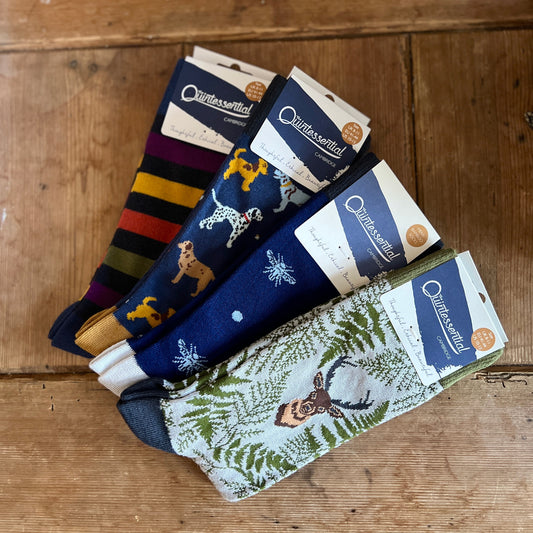 Set of men's socks with various designs on a wooden surface