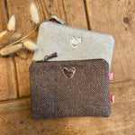 Load image into Gallery viewer, Two zipped purses with heart designs on a wooden surface
