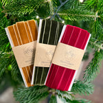 Load image into Gallery viewer, Three packages of velvet ribbons in gold, green, and red hanging on a Christmas tree.
