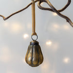 Load image into Gallery viewer, Gold pear hanging from a branch with a soft light background
