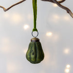 Load image into Gallery viewer, Green pear hanging from a branch with a soft light background
