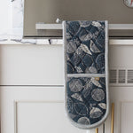 Load image into Gallery viewer, Blue Oven mitt with lemon, leaf pattern hanging on a kitchen cabinet handle.
