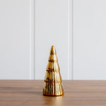 Load image into Gallery viewer, Gold decorative Christmas tree on a wooden surface with a white paneled background
