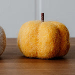 Load image into Gallery viewer, Felt decorative pumpkin on a wooden surface with a light grey wall background.
