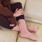 Load image into Gallery viewer, Person wearing pink socks sitting on a beige couch.
